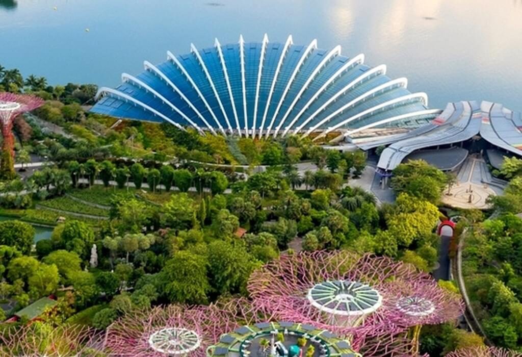 "Stunning skyline of Singapore at night, with iconic landmarks like Marina Bay Sands, Gardens by the Bay, and the Singapore Flyer illuminated against the waterfront."